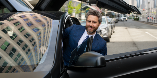 Car service Atlanta chauffeur is getting in the car for hourly as directed limo service
