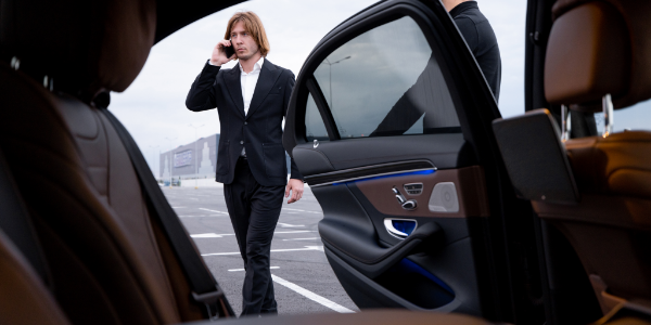 Executive getting in a car service Atlanta luxury sedan for Long-Distance Trips